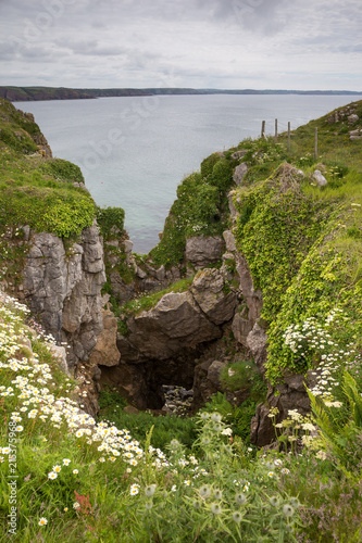 Obraz na plátně View towards a blowhole and the sea from the Pembroke Coast Path near Stackpole