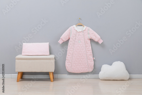 Simple, white baby bedroom with cot and rug photo