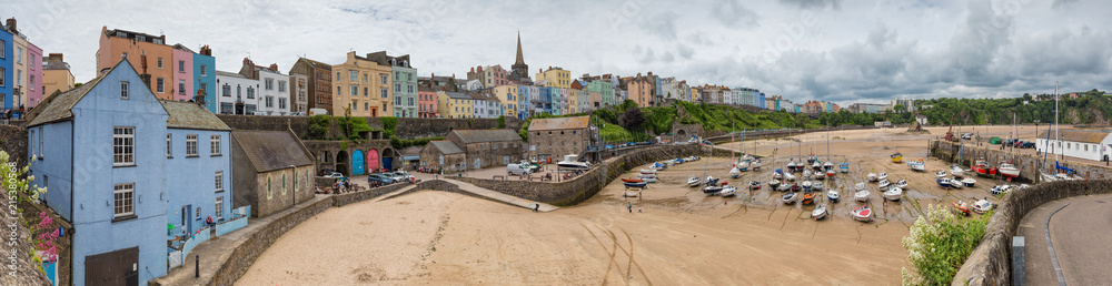 Fototapeta premium Tenby fishing port harbour at low tide, captured in a panoramic view