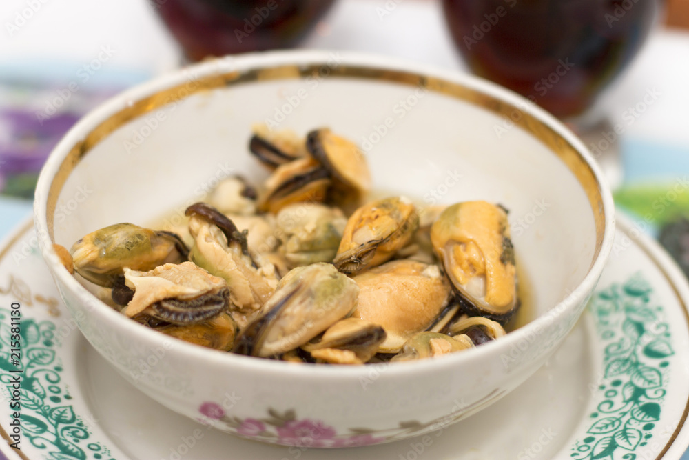 Tasty oiled pickled mussels iin a plate on the table Tasty oiled pickled mussels iin a plate on the table