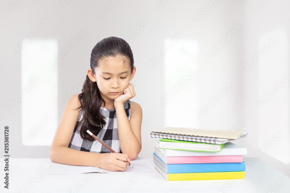 Cute asian kid concentrate on her homework a concept for education Cute asian kid concentrate on her homework a concept for education