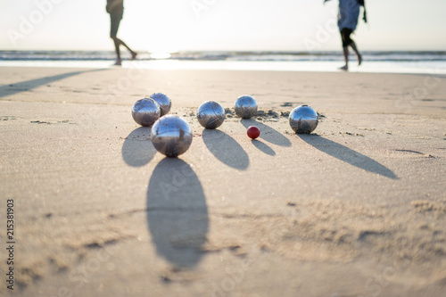 petanque balls on sandy beach photo