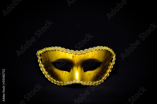 Fantasy mystery golden mask isolated on black background - Halloween & murder concept.