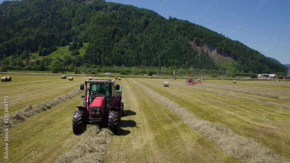 Harvesting fields of produce into rolled bales for storage - Aerial View Harvesting fields of produce into rolled bales for storage - Aerial View