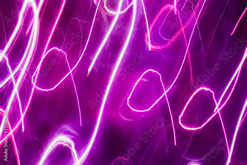Blurred colorful lights in motion. Abstract background in purple tones © aleoks