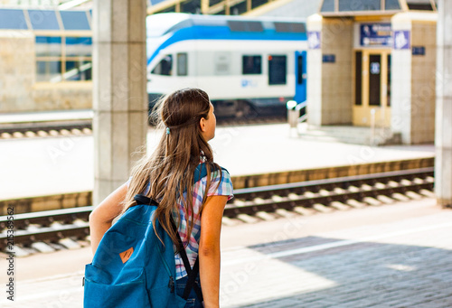 young teenager girl traveling alone at train station