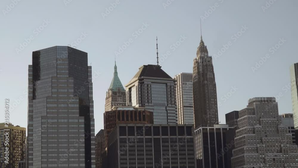 Close up shot of financial skyscrapers in downtown New York in Lower Manhattan filmed from the east river in late afternoon Close up shot of financial skyscrapers in downtown New York in Lower Manhattan filmed from the east river in late afternoon