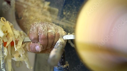 Turning or Lathing wood. Close up on hands and chisel. Slomo shots. photo