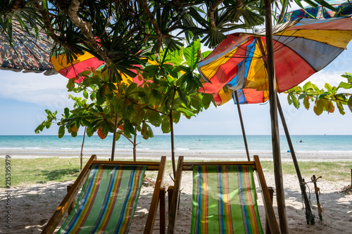 Fototapeta Naklejka Na Ścianę i Meble -  Mae Ram Phueng Beach, the beautiful and quiet for relaxation on the good holiday, is the attractions in Rayong, Thailand.  There are two seats on the front beach that under the palm trees, 