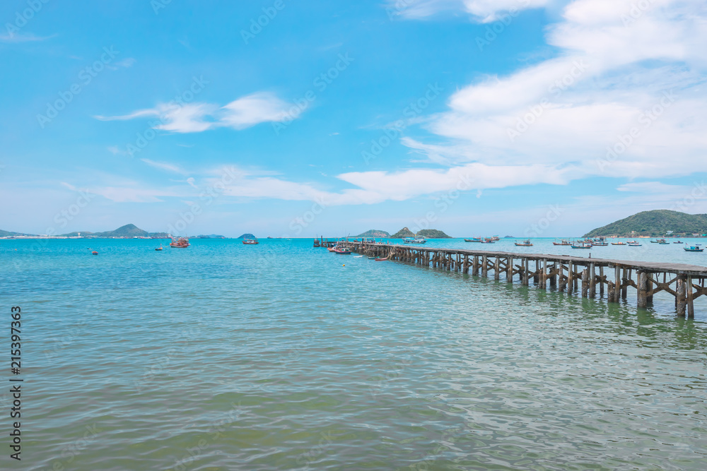 View of old wooden jetty along with the sea from the point under tree at Sattahip, Chonburi province, Thailand  