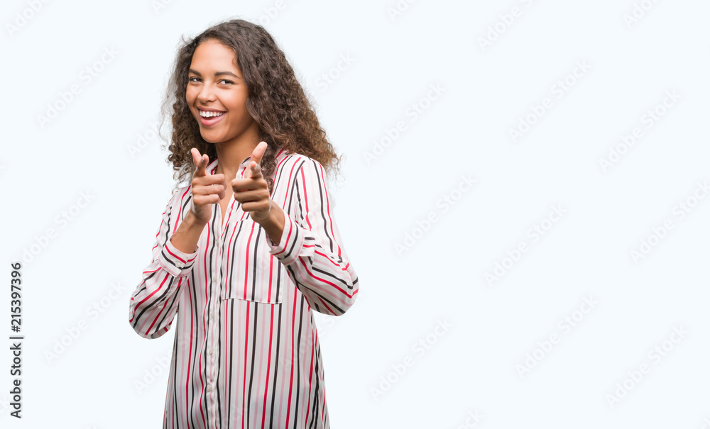 Beautiful young hispanic woman pointing fingers to camera with happy and funny face. Good energy and vibes. Beautiful young hispanic woman pointing fingers to camera with happy and funny face. Good energy and vibes.