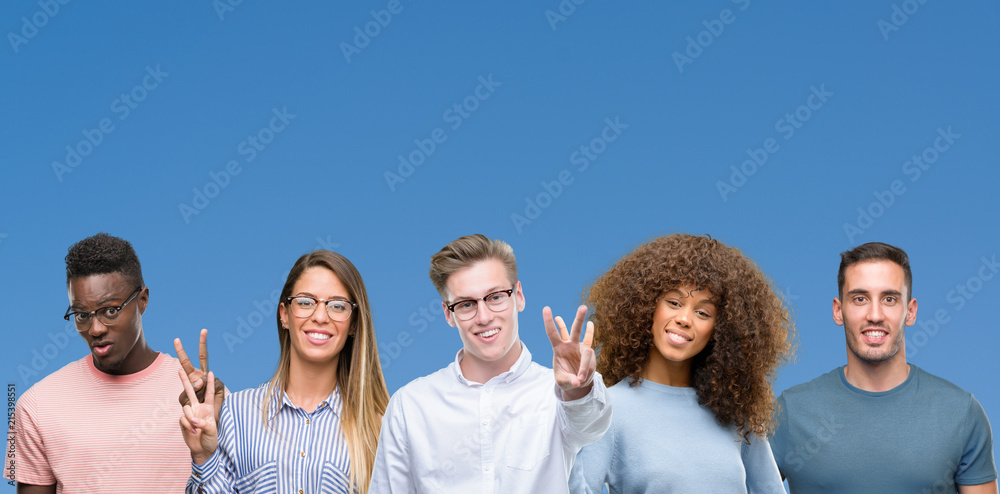 Composition of group of friends over blue blackground showing and pointing up with fingers number two while smiling confident and happy. Composition of group of friends over blue blackground showing and pointing up with fingers number two while smiling confident and happy.