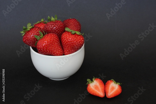 Red, ripe strawberries on black background 