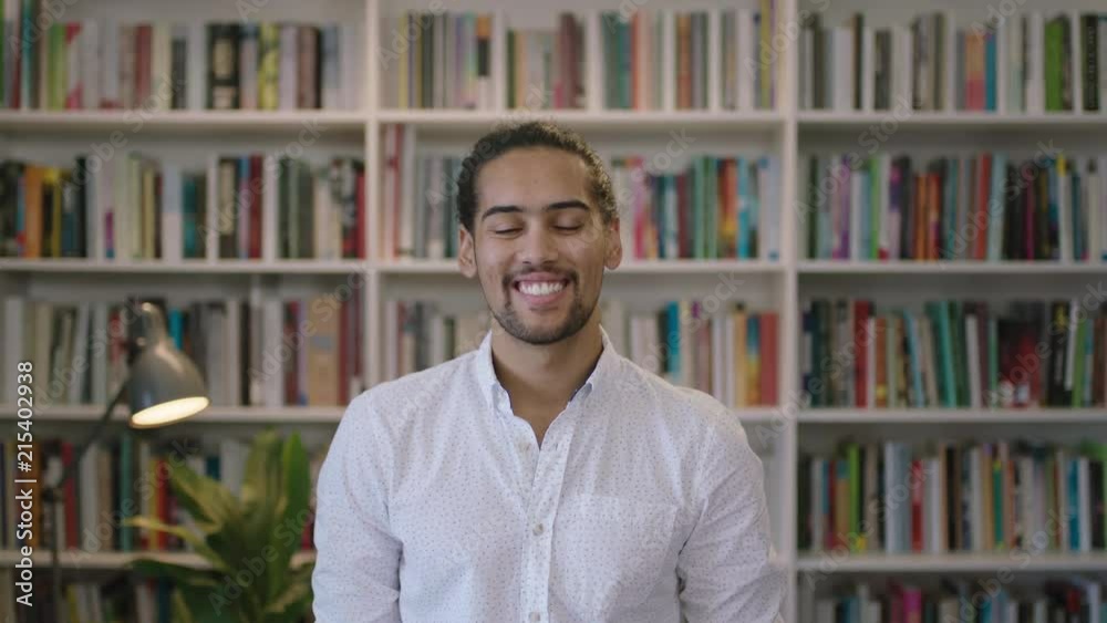 portrait of attractive young hispanic man student in library study smiling happy looking at camera enjoying learning education portrait of attractive young hispanic man student in library study smiling happy looking at camera enjoying learning education