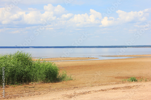 Baltic Sea Shore with Empty Sandy Beach in St. Petersburg, Russia. Summer Nature Landscape with Empty Beach and Calm Water Surface with No People on Bright Sunny Day.  © onajourney