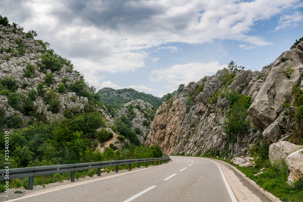 Concept picture of road trip in Montenegro, beautiful road pass through the greenery & stone mountain Concept picture of road trip in Montenegro, beautiful road pass through the greenery & stone mountain