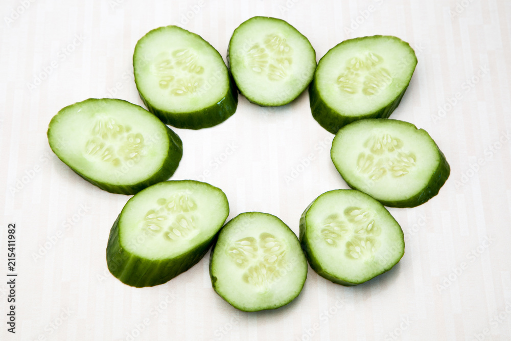 Isolated cucumbers. One whole cucumber and slices of cucumber isolated on white background Isolated cucumbers. One whole cucumber and slices of cucumber isolated on white background