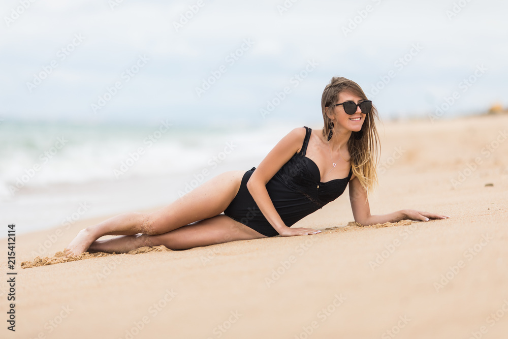 Young beauty woman lying on the sand the ocean coast