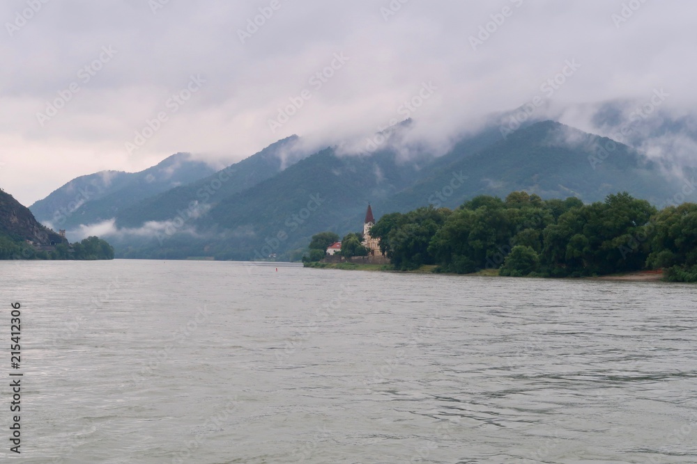 Cloudy day river cruise in Austria