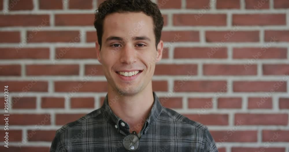 portrait attractive young hispanic man laughing enjoying successful lifestyle independent male satisfaction brick wall background portrait attractive young hispanic man laughing enjoying successful lifestyle independent male satisfaction brick wall background