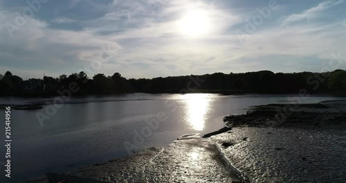 Sun reflecting off of coastline at sunset.