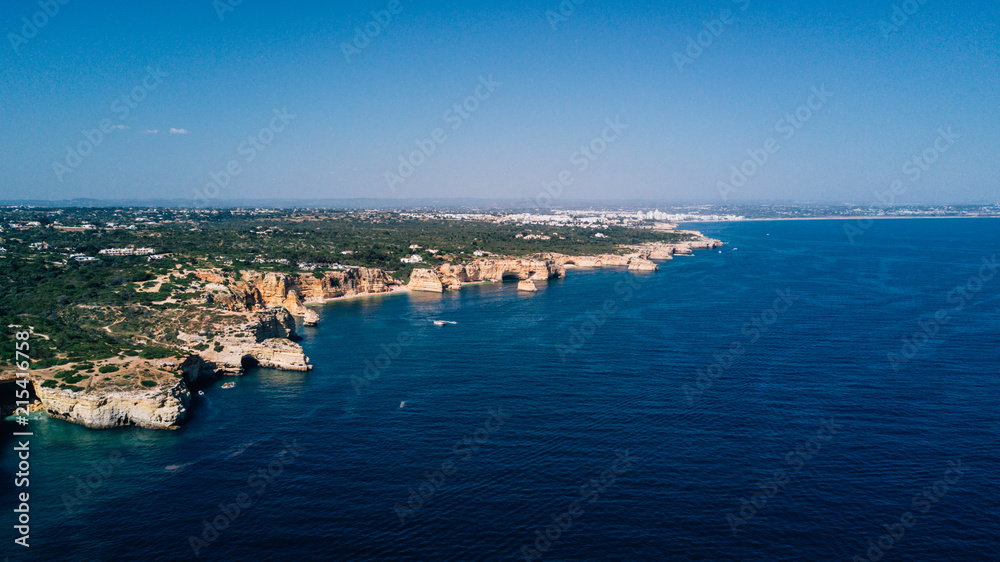 Aerial view of Algarve coast. Beautiful natural beaches with cliff and rocks from above