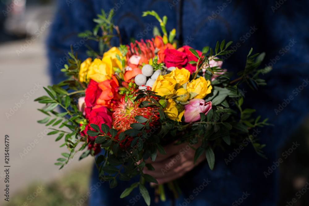 Bright unusual elegant autumn bouquet in hands of the florist girl