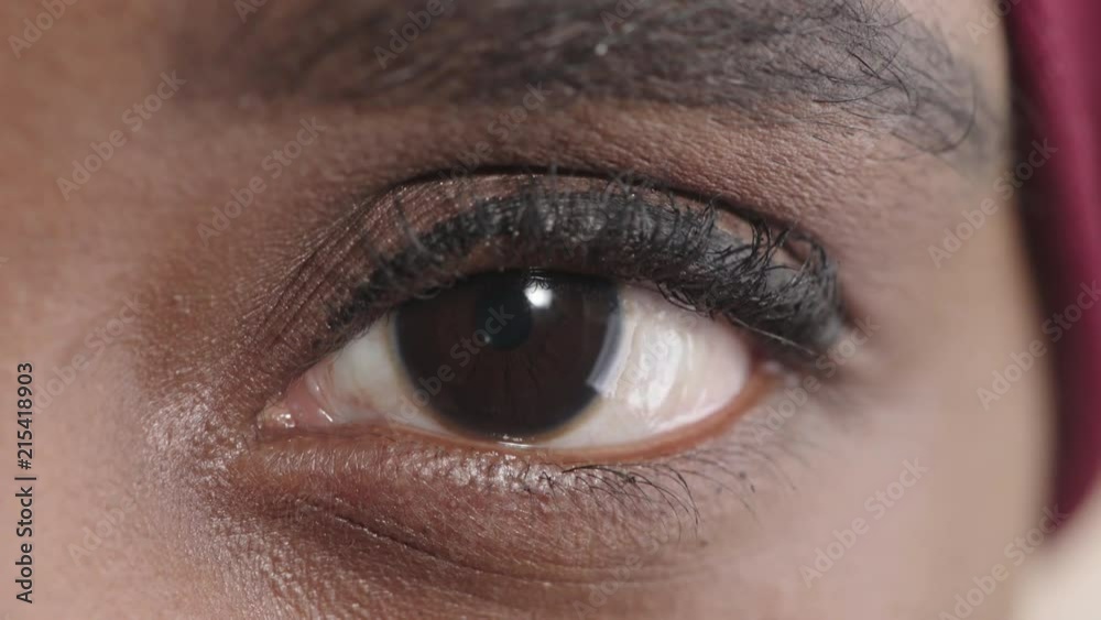 close up black woman eye blinking looking at camera pensive contemplative