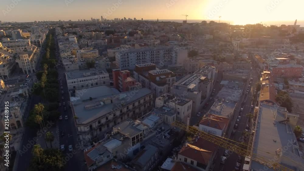 The bright golden sun sets over Jaffa Beach in Tel Aviv in an aerial shot as the camera pans across the city below The bright golden sun sets over Jaffa Beach in Tel Aviv in an aerial shot as the camera pans across the city below
