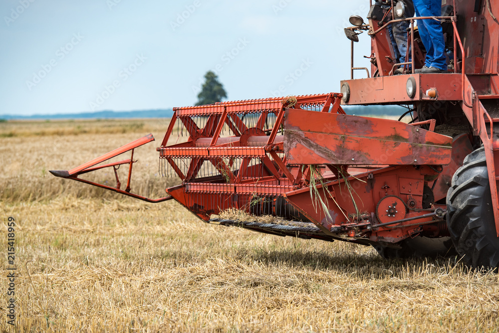 combine harvester that is harvesting wheat on summertime combine harvester that is harvesting wheat on summertime