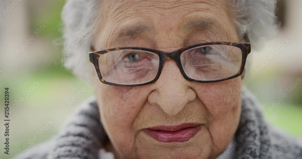 close up portrait of retired old woman feeling tired sleepy looking at camera in garden background close up portrait of retired old woman feeling tired sleepy looking at camera in garden background