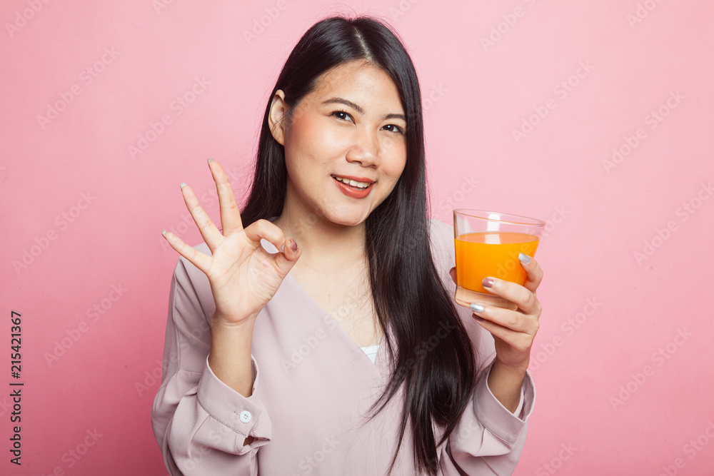 Young Asian woman show OK drink orange juice. Young Asian woman show OK drink orange juice.