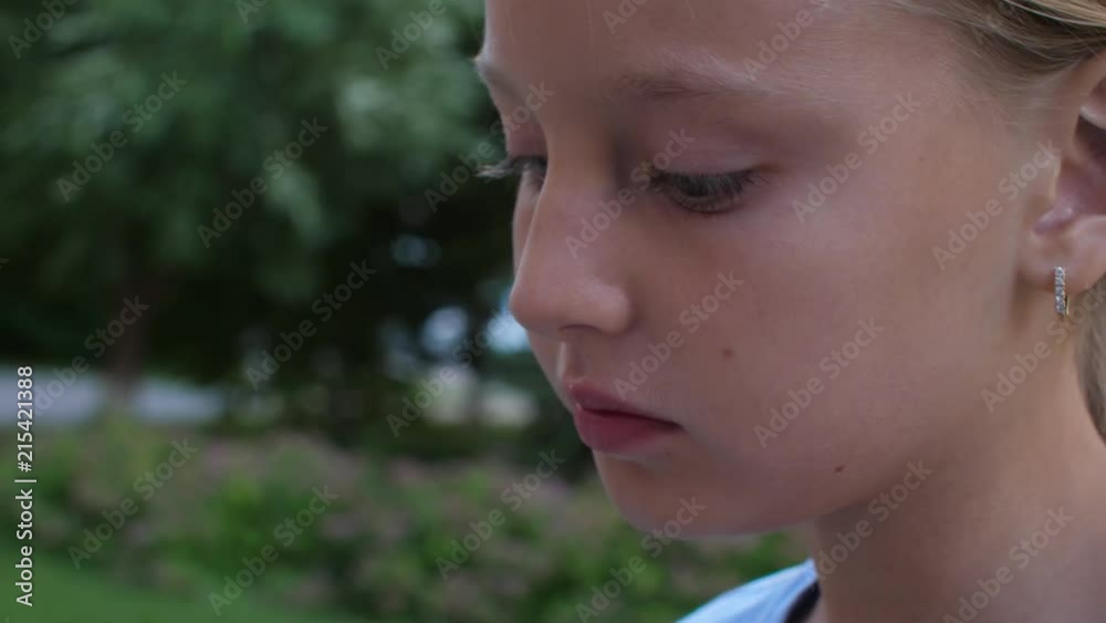 Face teenager e girl eating yellow ice cream outdoor extreme close up Face teenager e girl eating yellow ice cream outdoor extreme close up