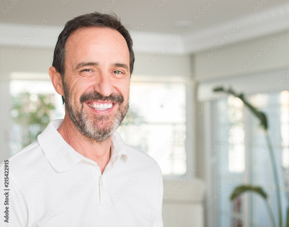 Handsome middle age man with a happy face standing and smiling with a confident smile showing teeth Handsome middle age man with a happy face standing and smiling with a confident smile showing teeth