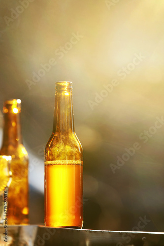 Bottles With Beer On Table Outdoors Closeup