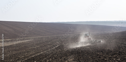 фотографія Harrowing the soil with disc harrows