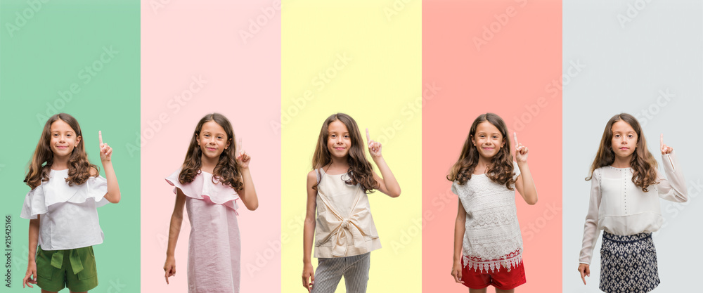 Obraz premium Collage of brunette hispanic girl wearing different outfits showing and pointing up with finger number one while smiling confident and happy.