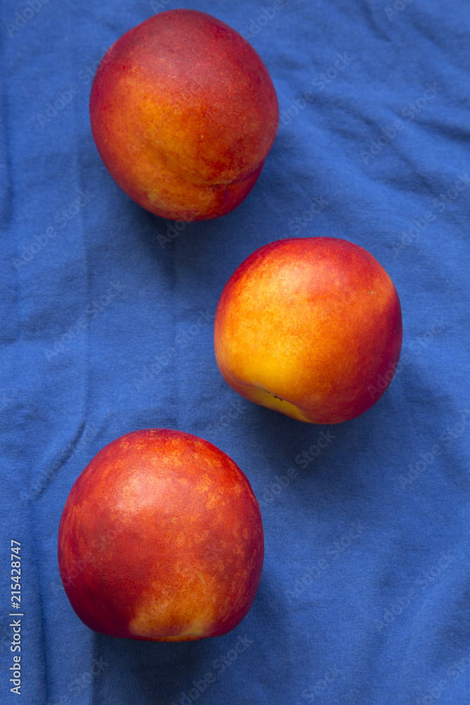 Nectarines on a blue cloth, top view. Nectarines on a blue cloth, top view.