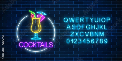 Neon cocktail glass sign in circle frame with alphabet. Glowing gas advertising with glass of alcohol shake.