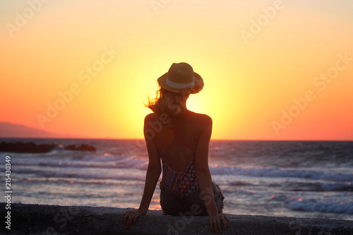 Young beautiful girl closeup near the sea at the sunset © volhavasilevich