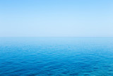 Beautiful seascape without clouds. Perfectly clean smooth sea and clear blue sky