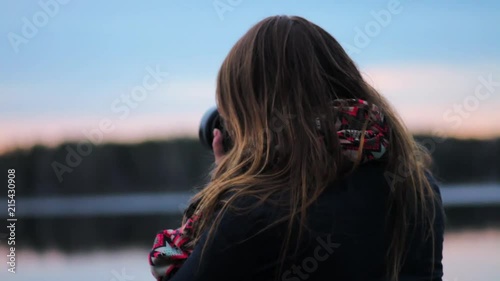 Girl photographing sunset photo