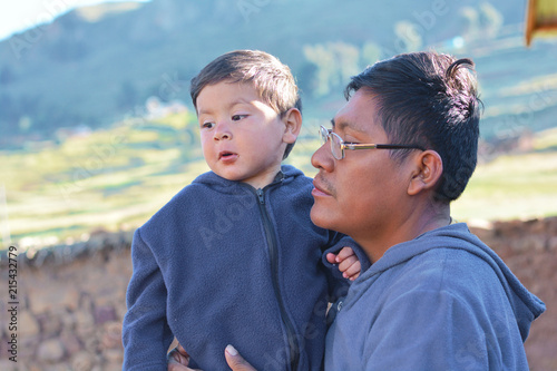 Bild auf Leinwand Native american man with his little son in the countryside.