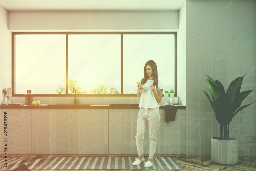 Minimalistic white kitchen interior, woman