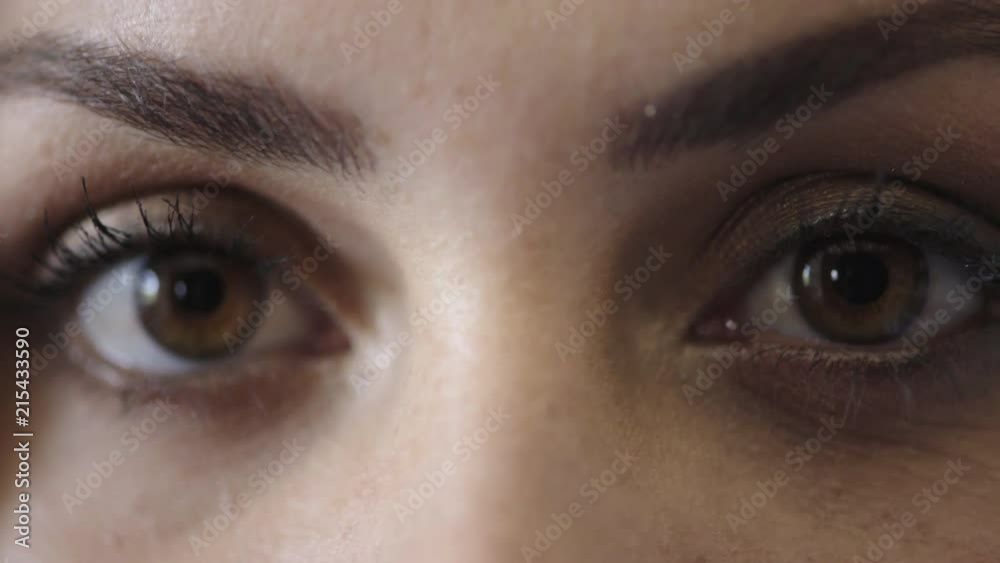 close up of woman eyes opening looking at camera wearing makeup cosmetics close up of woman eyes opening looking at camera wearing makeup cosmetics