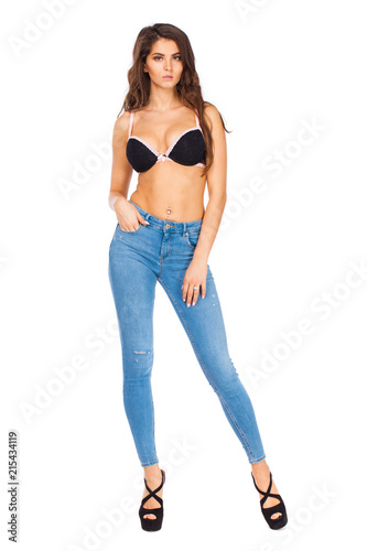 Young beautiful brunette woman in blue jeans