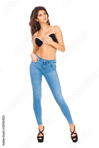 Young beautiful brunette woman in blue jeans © Andrey_Arkusha