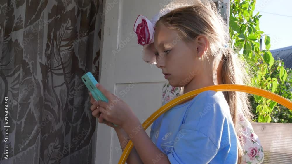 Happy teenager girl using mobile phone for funny communication with fiends Happy teenager girl using mobile phone for funny communication with fiends