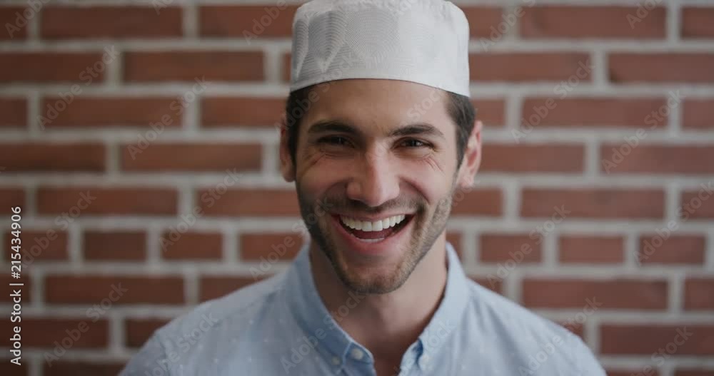 portrait attractive young muslim man laughing enjoying successful lifestyle happy independent male wearing kufi hat slow motion portrait attractive young muslim man laughing enjoying successful lifestyle happy independent male wearing kufi hat slow motion