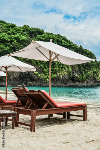 Beach lounge chairs with umbrella
